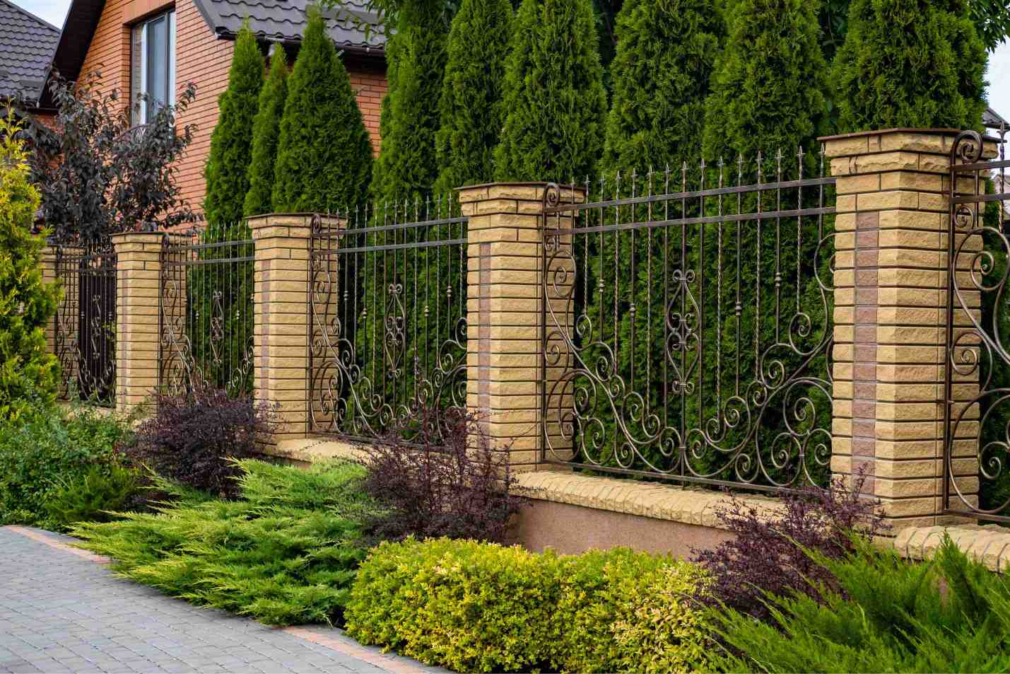 Wrought Iron Fence with Brick Pillars